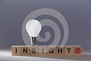 Creative insight. New idea generation, innovation. Originative thinking, innovative. Wooden cubes in line and lightbulb