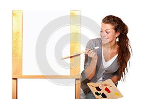 The creative juices are about to flow...Studio shot of a young woman holding a palette and brush and standing with an