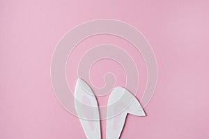 Creative layout cute bunny ears on a pink background Easter minimalist concept flat lay top view