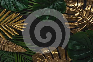 Creative layout with gold and green tropical palm leaves on black background. Minimal summer abstract pattern