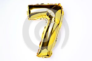 Creative layout. Golden foil balloon number and digit seven 7. Birthday greeting card. Anniversary concept. Top view