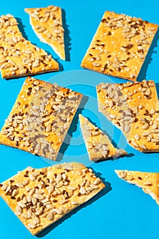 Creative layout made of crunchy cereal cookies on bright blue background. Healthy dessert concept