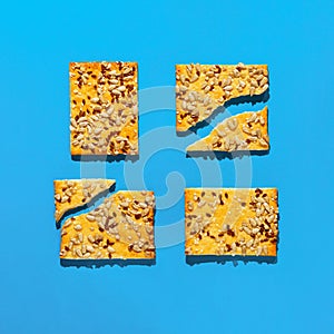 Creative layout made of crunchy cereal cookies on bright blue background. Healthy dessert concept