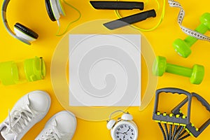 Creative layout made of sports equipment on yellow background