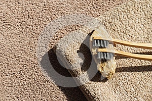 Creative layout made of two toothbrushes on beige towel background . Morning routine concept. Minimal style