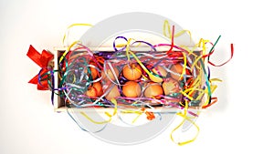 Creative layout made of white chicken eggs in wooden box with colorful confetti with trendy neon colors on white