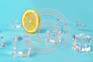 Creative layout made of yellow lemon wheel and ice cube on blue color background.