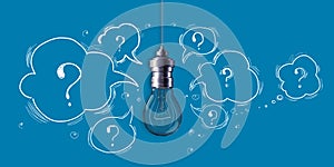 Creative light bulb sketch with questions on blue background. Idea, innovation and creativity concept.