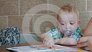 Creative little boy playing with finger paint