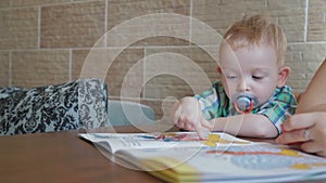 Creative little boy playing with finger paint