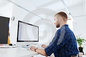 Creative man or programmer with computer at office