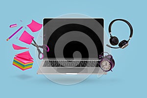 Creative minimal composition made with a laptop, headphones, school supplies and alarm clock flying in the air. Back to school