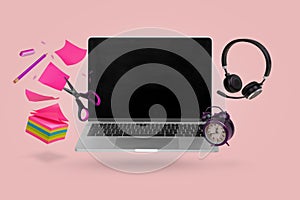 Creative minimal composition made with a laptop, school supplies, headphones and alarm clock flying in the air