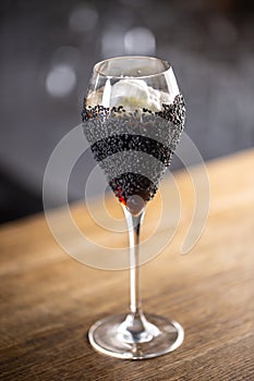 Creative mixology cocktail served in a champaign glass photo