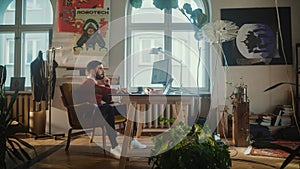 Creative Modern Office: Young Man Sitting at His Desk Working on Computer. Authentic Professio