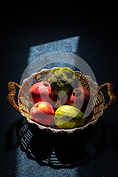 Creative moody shot of fruit and vegitable in a golden basket