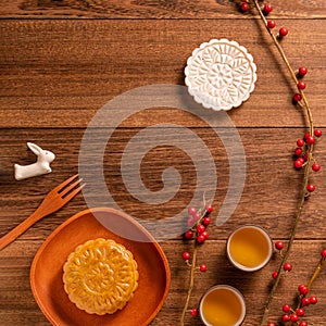 Creative Moon cake Mooncake table design - Chinese traditional pastry with tea cups on wooden background, Mid-Autumn Festival
