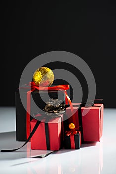 creative new year gifts red-black on white table and dark background
