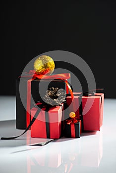 creative new year gifts red-black on white table and dark background