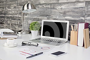 Creative office desktop with blank laptop photo
