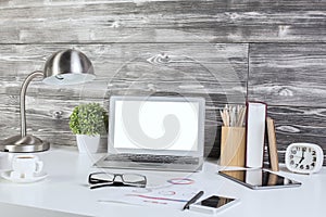 Creative office desktop with blank white laptop