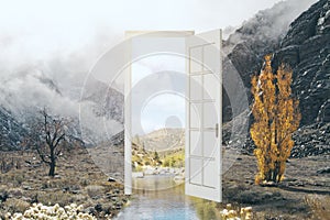 Creative open door leading to beautiful landscape. Dream, opportunity and success concept.
