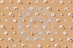 Creative pattern made with garlic on beige background. Healthy food concept .Minimal styl