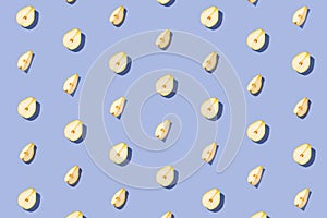 Creative pattern made of raw sliced pears on blue pastel background with shadows. Minimal style. Healthy food ingredient concept.