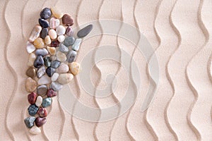 Creative pebble map of Argentina on beach sand