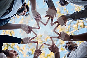 Creative people, hands and star in teamwork, solidarity or collaboration for unity in nature. Low angle of team group