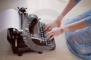 A creative person, author of books, writer of bestsellers,a journalist typing on an old typewriter. Inspiration in the