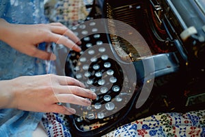 A creative person, author of books, writer of bestsellers,a journalist typing on an old typewriter. Inspiration in the