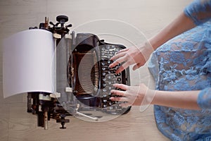 A creative person, author of books, writer of bestsellers,a journalist typing on an old typewriter. Inspiration in the