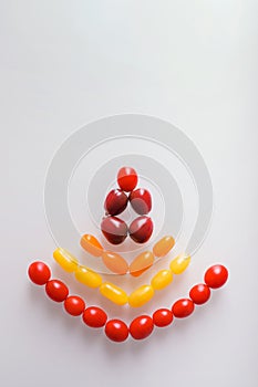 Creative photo design of various colorful cherry tomatoes on white background. Top view of colorful cherry tomatoes, flat lay