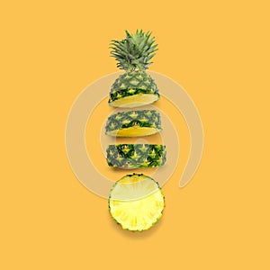 Creative pineapple layout. Whole fruit on bright yellow