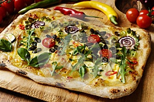 Creative pizza slice: Flower Garden with vegetables, pumpkin seeds, green onion, Hollandaise sauce and hot chili.