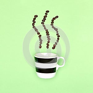 Creative pop art cup of coffee pastel coloured background. Coffee mug and roasted coffee beans.