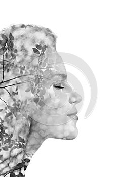 Creative portrait of beautiful young woman made from double exposure effect using photo of nature, isolated on white background