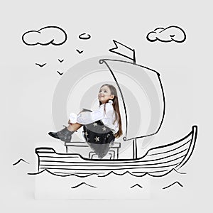 Creative portrait of cute kid, little girl sailing on drawn boat isolated on grey background with pencil sketch
