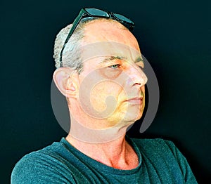 Creative portrait. Middle aged man with glasses. Portrait of mature man on black background. Copy space