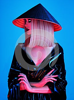 Creative portrait of model in asian hat and latex clothing