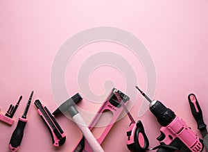 Creative provocation: a flat layout of pink hand tools on a pink background. photo