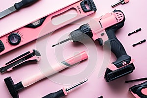 Creative provocation: a flat layout of pink hand tools on a pink background. photo