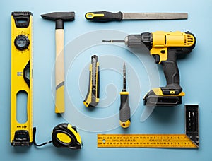 Creative provocation: a flat layout of yellow hand tools on a blue background. photo