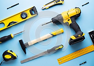 Creative provocation: a flat layout of yellow hand tools on a blue background. photo