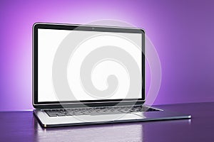 Creative purple designer workplace with blank white mock up laptop screen .