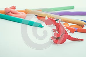 Creative red dinosaur clay model. Play dough animal. Vintage ton