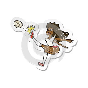 A creative retro distressed sticker of a cartoon female soccer player kicking ball