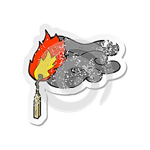 A creative retro distressed sticker of a cartoon flaming match