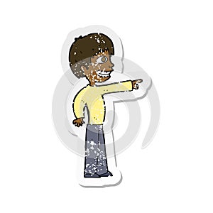 A creative retro distressed sticker of a cartoon grinning boy pointing